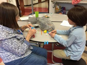 AYS staff member helping student with STEM project