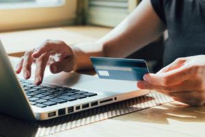 Person using credit card to make an online purchase
