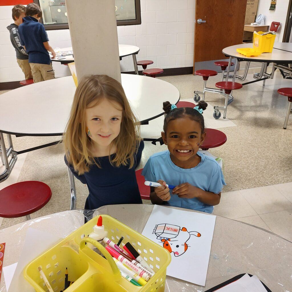 Two girls smiling in AYS before and after school program